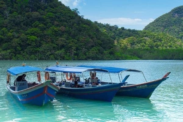 Island hopping boats moored in lagoon, Langkawi